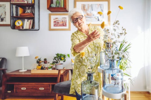 senior woman at home - home decoration stock pictures, royalty-free photos & images