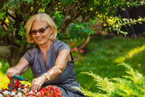 senior woman gardening on beautiful spring day - garden decoration stock pictures, royalty-free photos & images