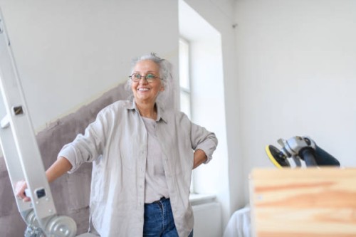 senior woman having break during reconstructing her apartment. - home decoration stock pictures, royalty-free photos & images