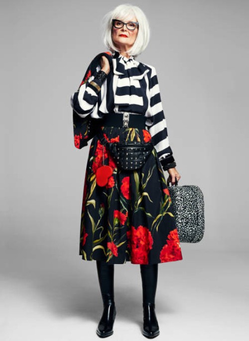 senior woman holding suitcase wearing stylish clothes - fashion stock pictures, royalty-free photos & images