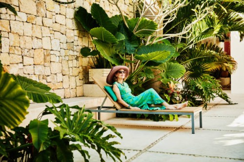 senior woman relaxing in lounge chair at tropical spa - fashion stock pictures, royalty-free photos & images