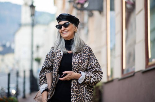 senior woman with extravagant clothes walking outdoors in town. - fashion stock pictures, royalty-free photos & images