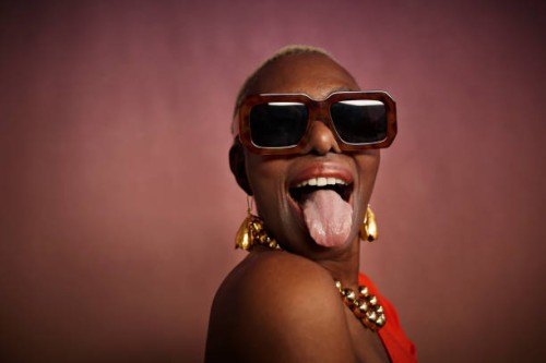 senior woman with eyeglasses sticking out tongue - fashion stock pictures, royalty-free photos & images