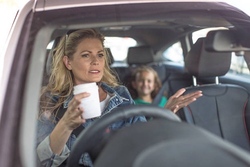 serious woman and girl in car - junk food stock pictures, royalty-free photos & images