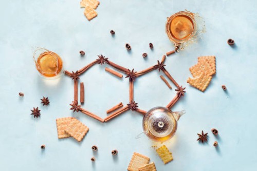 serotonin molecule made out of cinnamon and teacups with splashes. creative drink flat lay with the hormone of joy. - food stock pictures, royalty-free photos & images