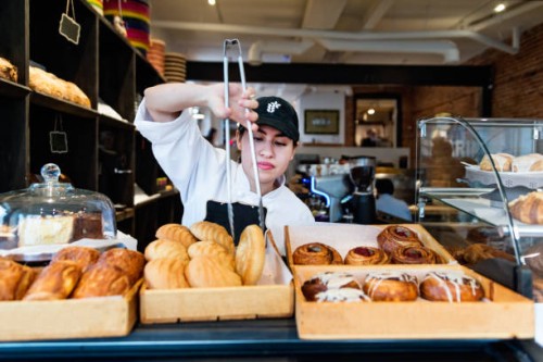 service at the counter for owner of a small bakery shop. - food stock pictures, royalty-free photos & images