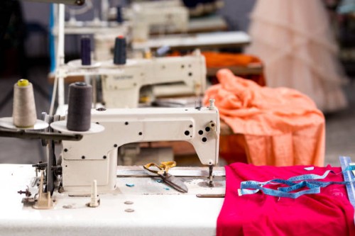 sewing or tailoring industrial hall with machinery - fashion stock pictures, royalty-free photos & images