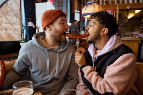 sharing a bratwurst sausage - food stock pictures, royalty-free photos & images