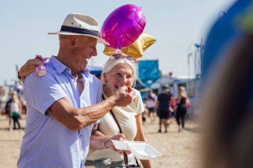 sharing lunch at the funfair - junk food stock pictures, royalty-free photos & images