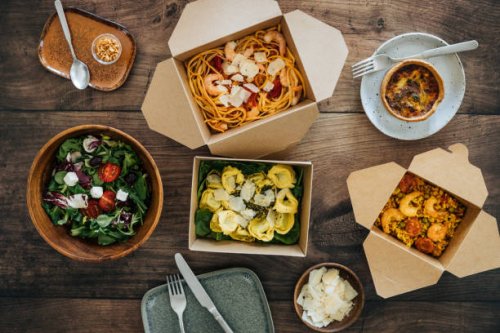 sharing takeaway meal on dining table - junk food stock pictures, royalty-free photos & images