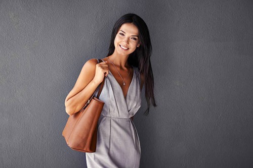 she's packing a purse and a smile - fashion stock pictures, royalty-free photos & images