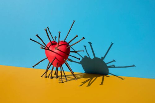shiny red heart shape with rusty nails inserted on the blue background - nails art stock pictures, royalty-free photos & images
