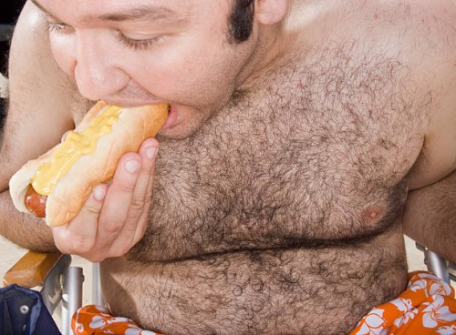 shirtless overweight man eating a hot dog - junk food stock pictures, royalty-free photos & images