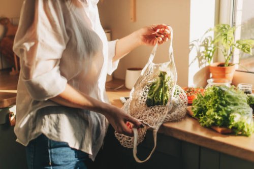 shopping bag with raw vegetables and fruits held by young woman in casualwear - food stock pictures, royalty-free photos & images