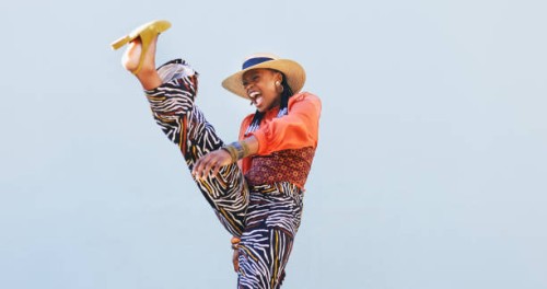 shot of a beautiful young woman having fun against an blue wall - fashion stock pictures, royalty-free photos & images
