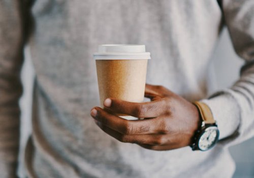 shot of a businessman holding a cup of coffee - junk food stock pictures, royalty-free photos & images