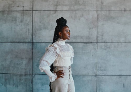 shot of a stylish young woman posing against a concrete wall - fashion stock pictures, royalty-free photos & images