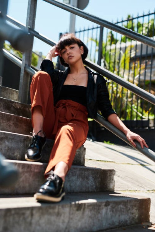 shot of a stylish young woman sitting outside on a staircase - fashion stock pictures, royalty-free photos & images