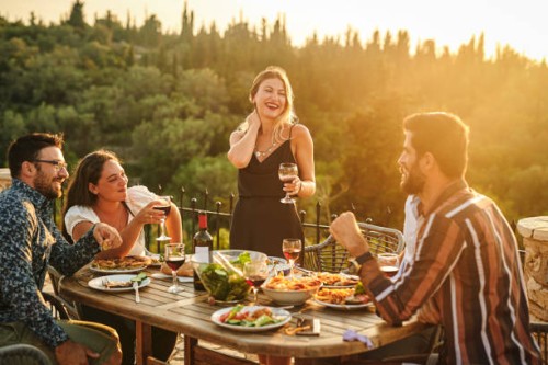 shot of a woman making a toast while at a gathering with her friends - food stock pictures, royalty-free photos & images