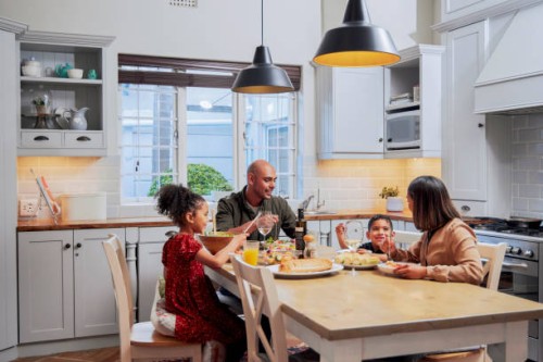 shot of a young family enjoying a meal together - food stock pictures, royalty-free photos & images