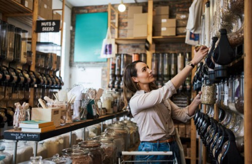 shot of a young woman filling a jar with product while shopping - home decoration stock pictures, royalty-free photos & images
