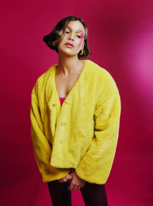 shot of a young woman posing against a pink background - fashion stock pictures, royalty-free photos & images