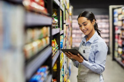 shot of a young woman using a tablet at work in a supermarket - food stock pictures, royalty-free photos & images
