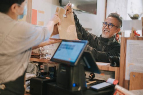 side hustle asian chinese senior man delivery picking up take away food from cashier - junk food stock pictures, royalty-free photos & images