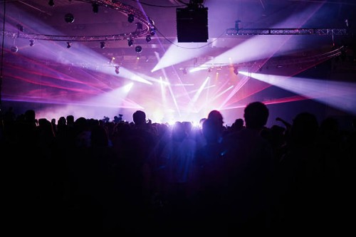 silhouette crowd facing stage at music festival - concert stock-fotos und bilder