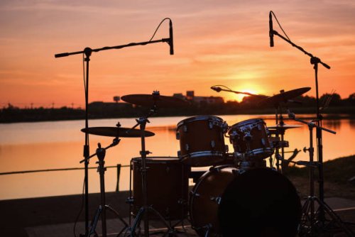 silhouette drum kit by the lake - concert stock pictures, royalty-free photos & images