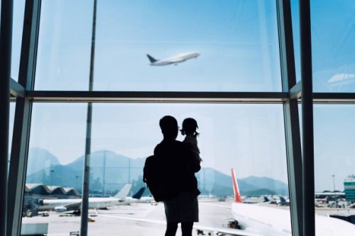 silhouette of joyful young asian father carrying cute little daughter looking at airplane through window at the airport while waiting for departure - travel stock pictures, royalty-free photos & images