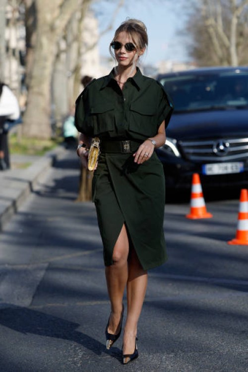 Simona Jakstaite wears green midi dress, gold Bottega Veneta bag, black heels with metallic detail, outside Elie Saab, during the Womenswear...