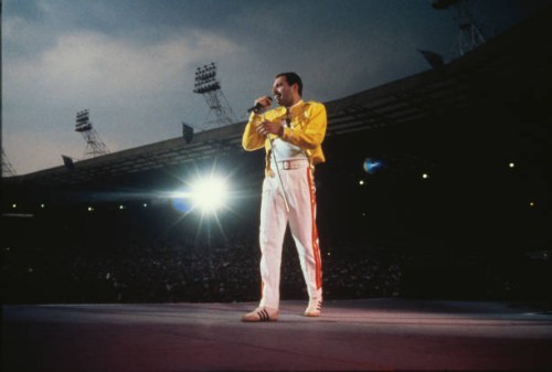 Singer Freddie Mercury performing with Queen at Wembley Stadium, London, July 1986. The band played two nights at the venue, as part of the Magic...