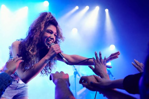 singer performing on stage reaching out to crowd - concert stock pictures, royalty-free photos & images