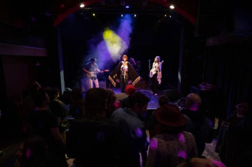 singer wearing cape performing on stage with band - concert stock pictures, royalty-free photos & images
