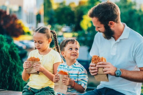 single father with kids eating fast food outside - junk food stock pictures, royalty-free photos & images