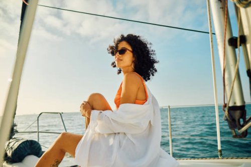 single young female experiences serene travel at sea - travel photos et images de collection