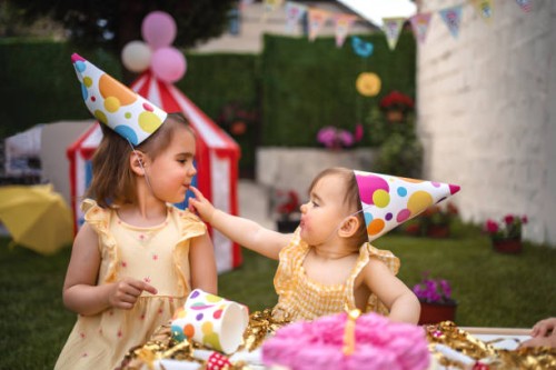 sisters having fun on a birthday party - home decoration stock pictures, royalty-free photos & images