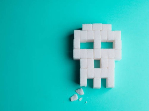 skull made of sugar cubes with a broken tooth. concept of tooth decay. - junk food stock pictures, royalty-free photos & images