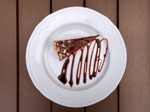 slice of chocolate cake on a wooden table - junk food stock-fotos und bilder