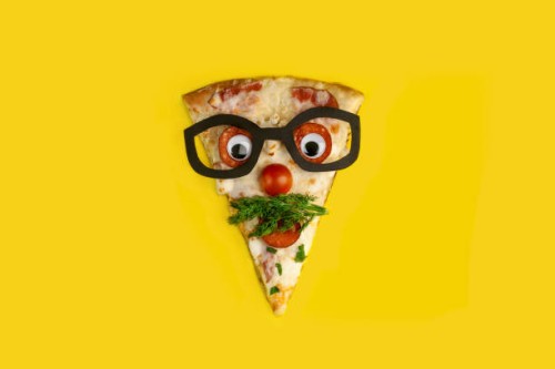 slice of pizza decorated as a surprised man in glasses on a yellow background - food stock pictures, royalty-free photos & images