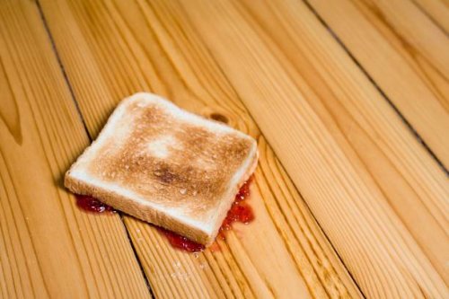 slice of toast with strawberry jam turned upside down on floor - food stock pictures, royalty-free photos & images