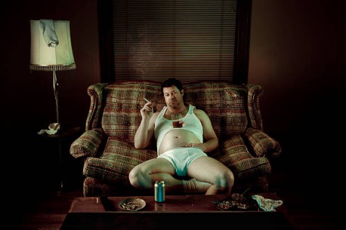 slob man watching television while smoking in underwear - junk food stock pictures, royalty-free photos & images