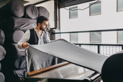 small business owner checking the fabric for the last time - fashion stock pictures, royalty-free photos & images