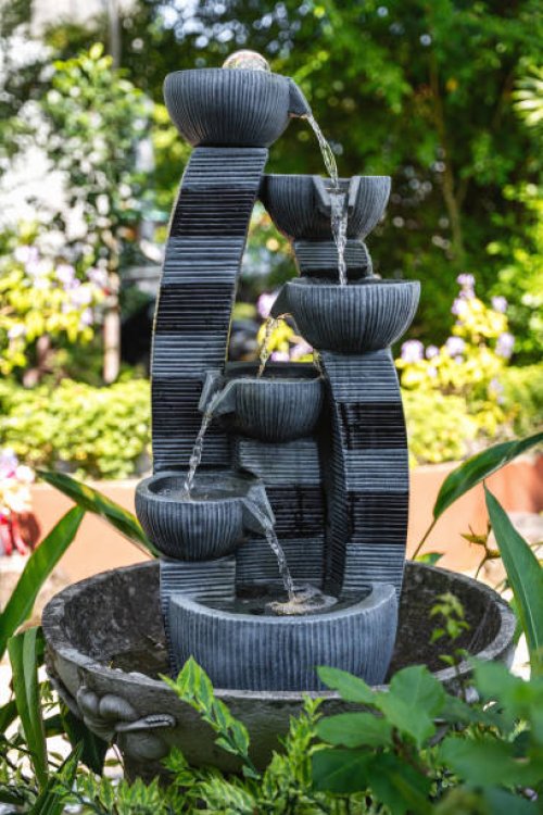 small tiered water fountain in lush green garden - garden decoration stock pictures, royalty-free photos & images