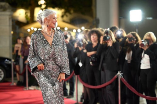 smiling actress in shiny gown posing at event - fashion stock pictures, royalty-free photos & images