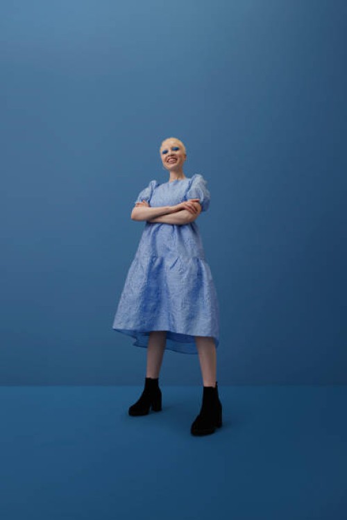 smiling albino woman standing with arms crossed - fashion stock pictures, royalty-free photos & images