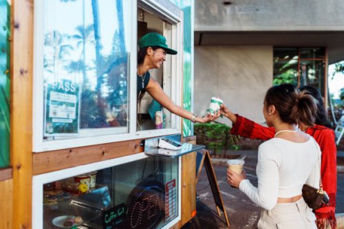 smiling barista hands coffee to customer - junk food stock pictures, royalty-free photos & images