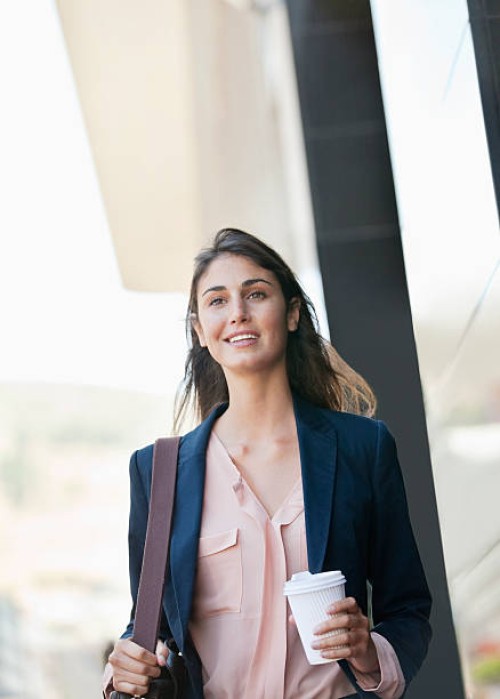 smiling businesswoman walking with coffee cup - junk food stock pictures, royalty-free photos & images