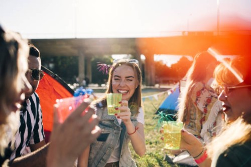 smiling friends enjoying drinks in music concert during summer - concert stock pictures, royalty-free photos & images